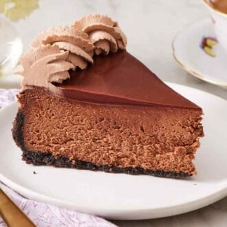 Close-up of a slice of chocolate cheesecake on a small plate.