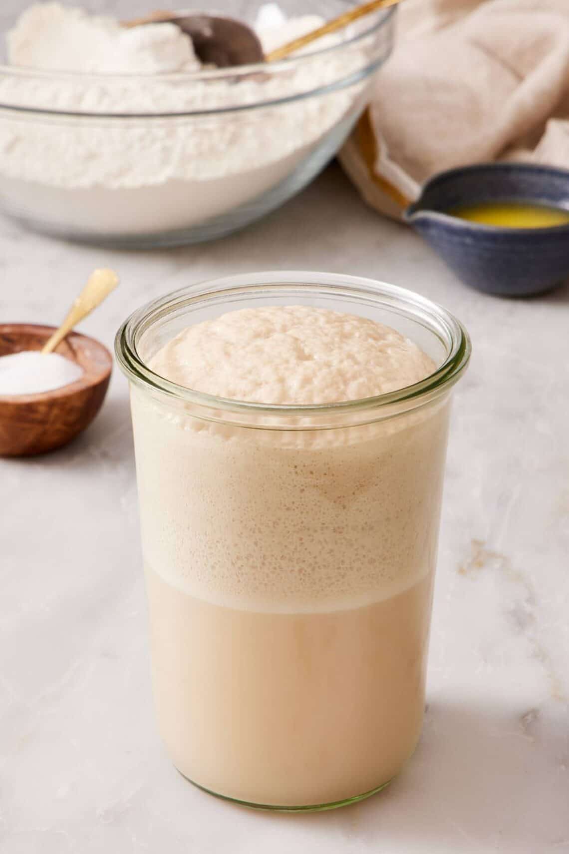 A jar of bloomed yeast with a foamy head.