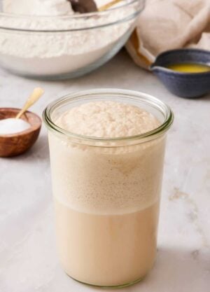 A jar of bloomed yeast with a foamy head.