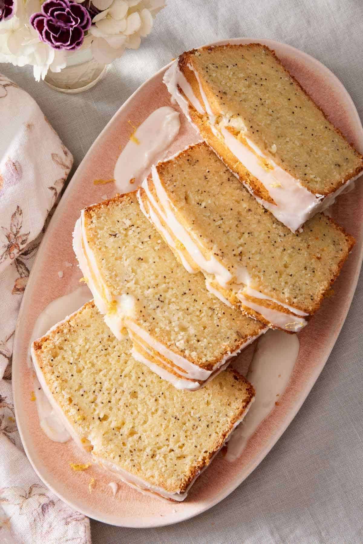 Overhead shot of sliced lemon poppy seed loaf on a platter.