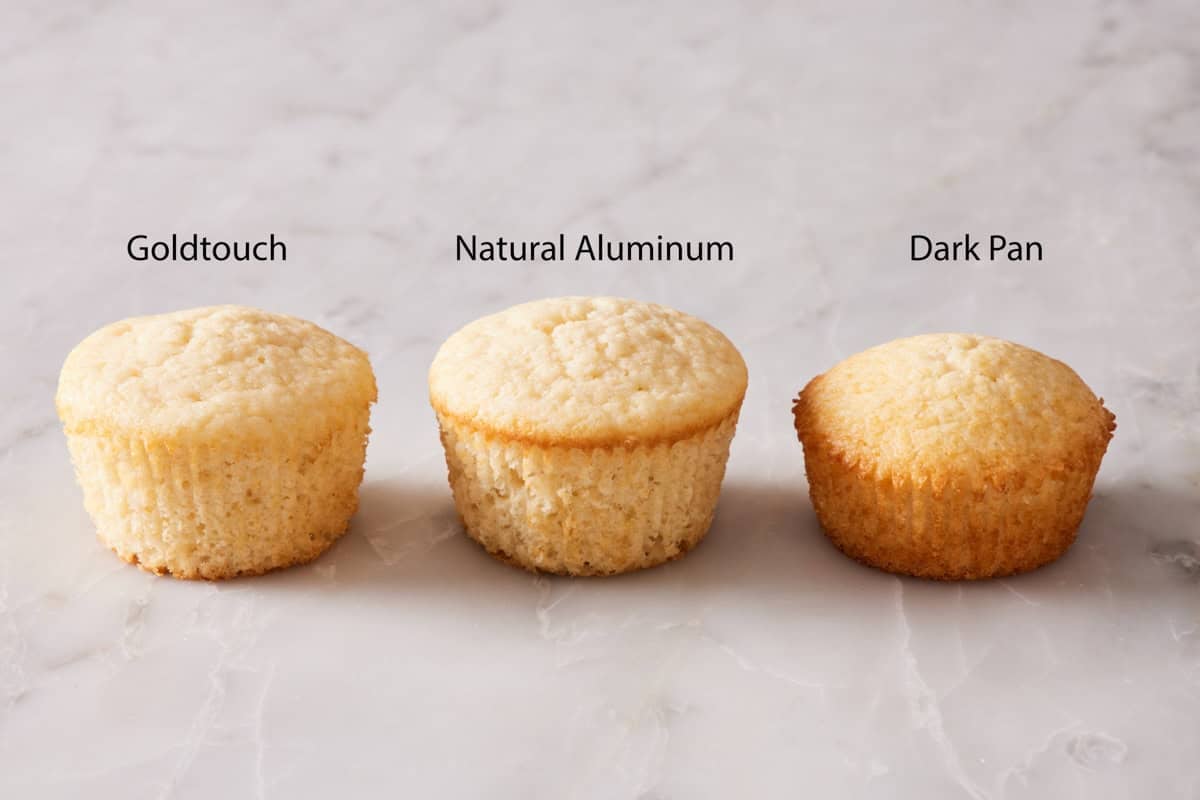 Three cupcakes showing the color difference when baked in pans of different materials.