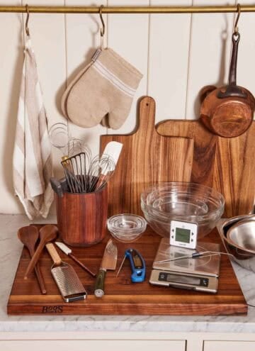 Various essential kitchen tools & utensils like oven mitts, cutting boards, spoons, and more.