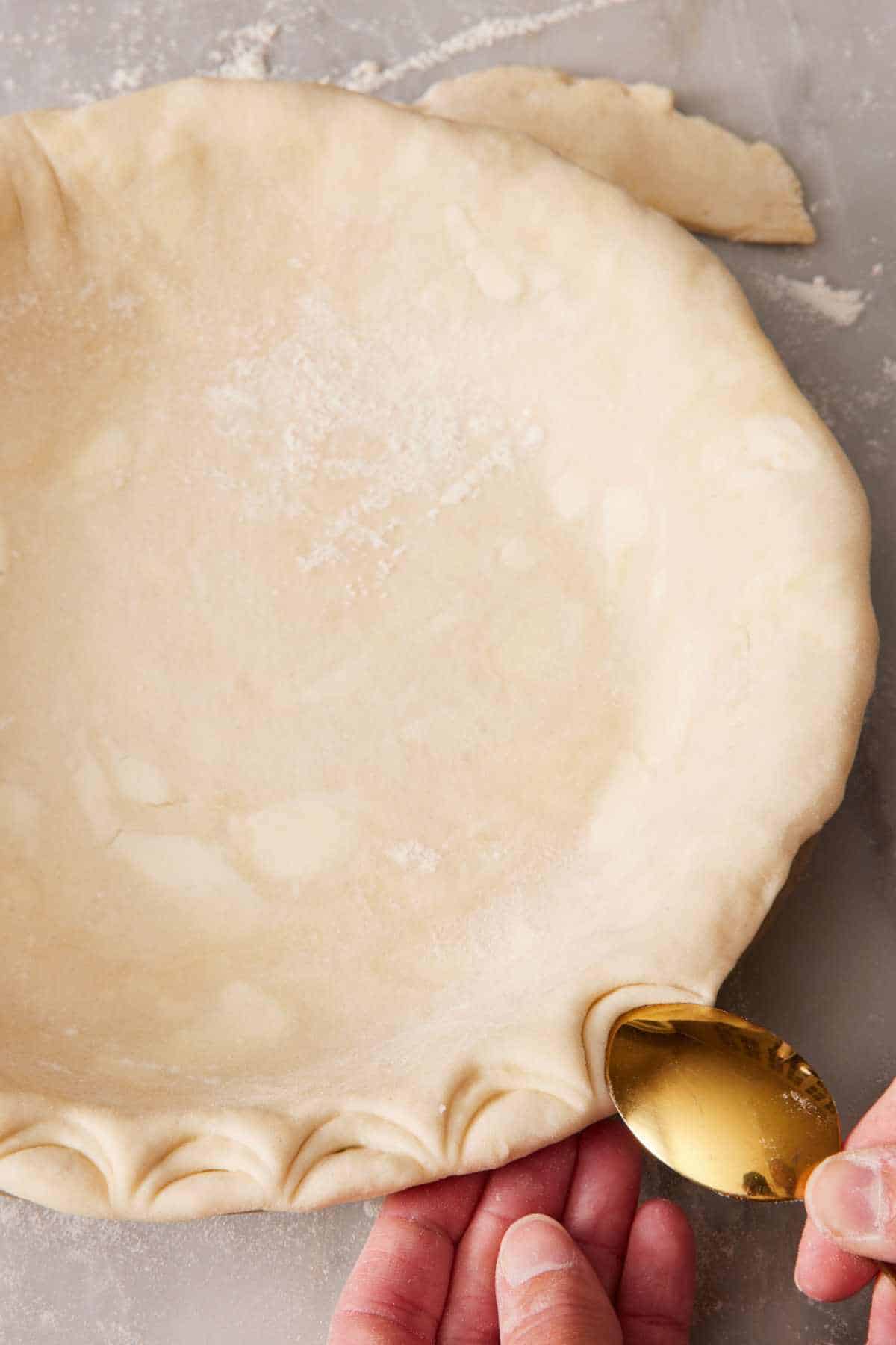 How to crimp pie crust with a spoon.