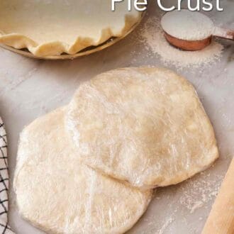 Pinterest graphic showing two discs of wrapped pie dough partially stacked, with a measuring cup of flour and a prepared pie crust in a pie dish in the background.