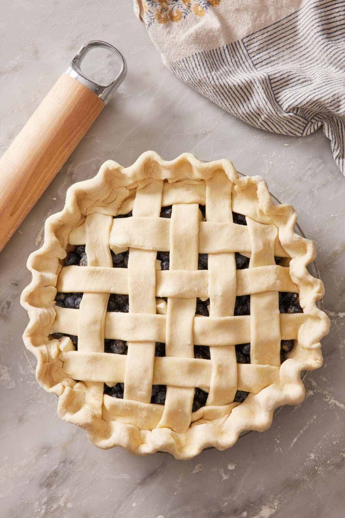 Overhead shot of an unbaked pie with a lattice top.