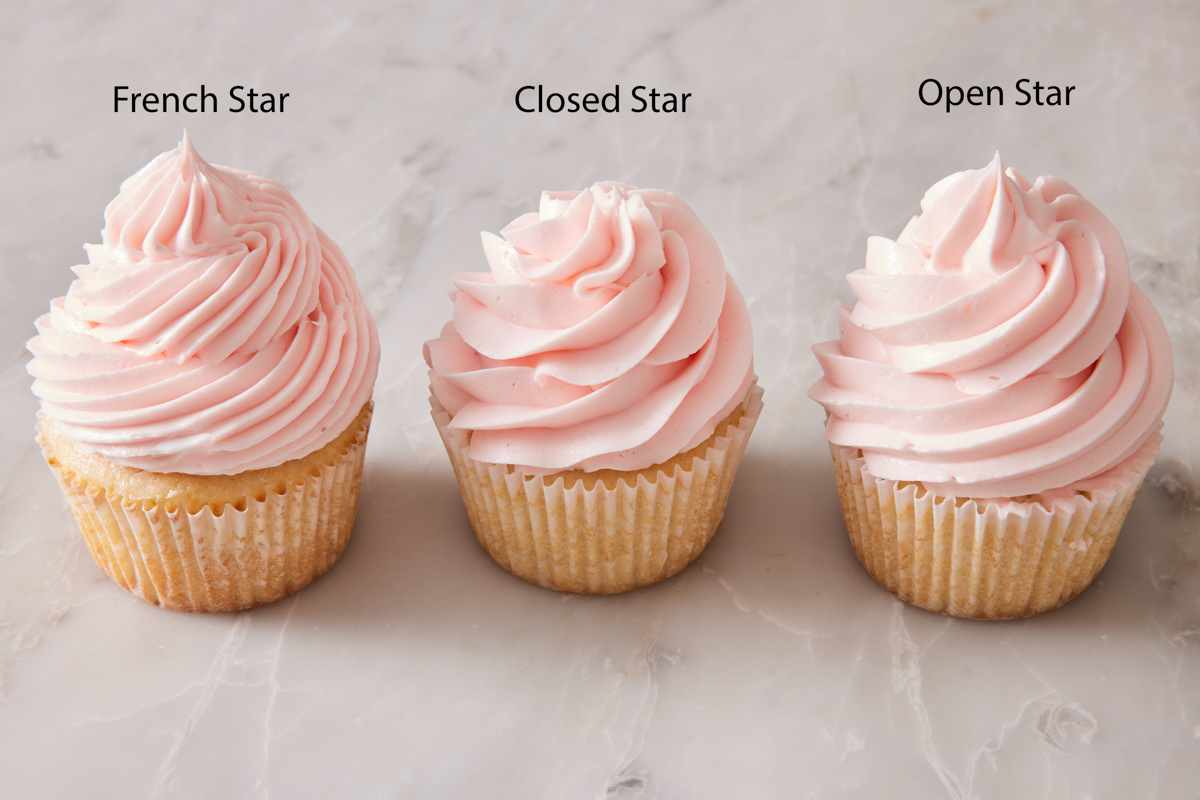 Three cupcakes in a row, one frosted with a French star tip, one with a closed star tip, and the last with an open star tip.
