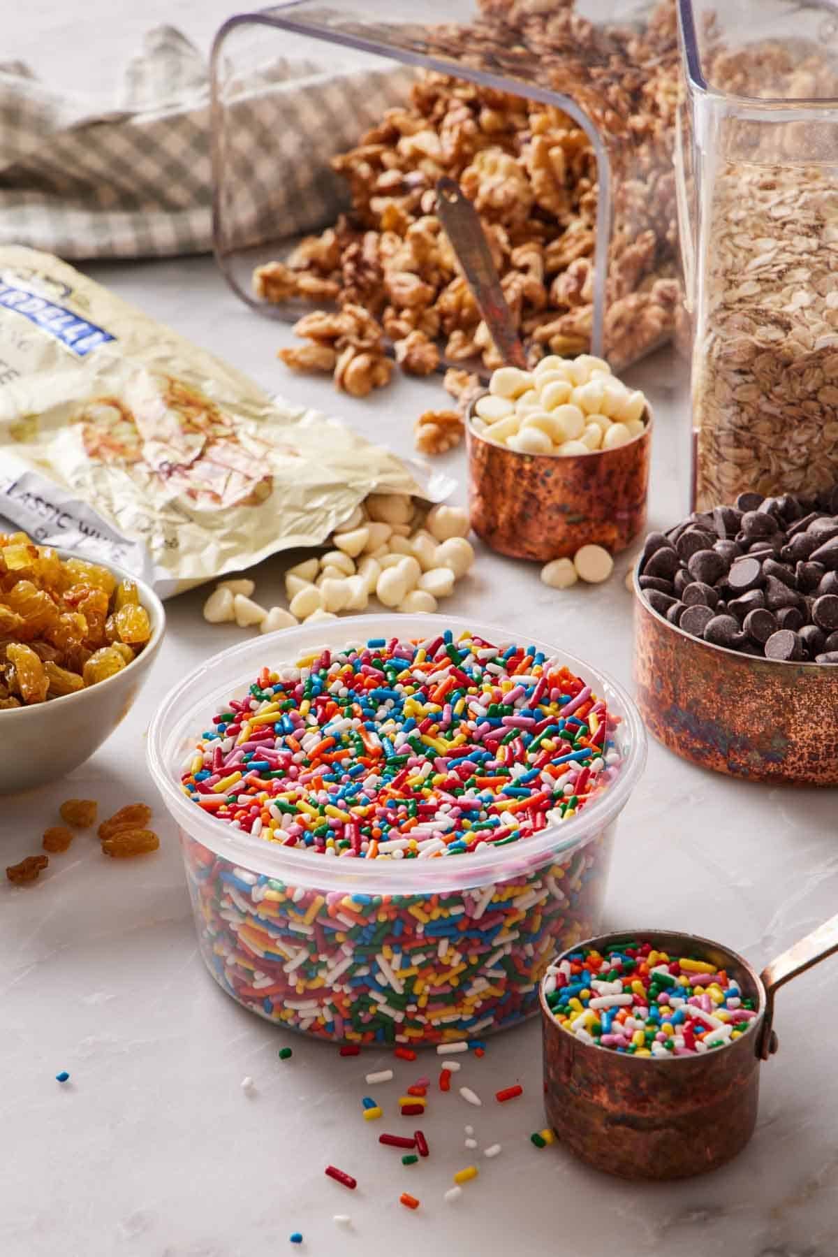 Various chunky baking ingredients on a marble countertop.