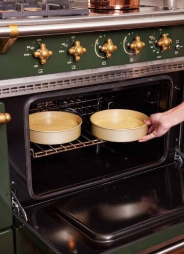 Two cake pans placed in an oven.