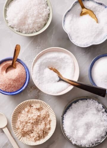 Overhead shot of bowls of different types of salt.