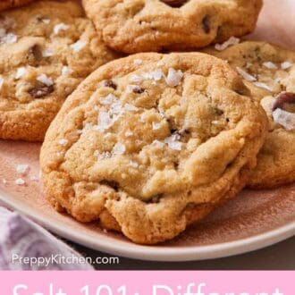 Pinterest graphic showing a close-up of choc chip cookies on a platter with flaky sea salt sprinkled on top.