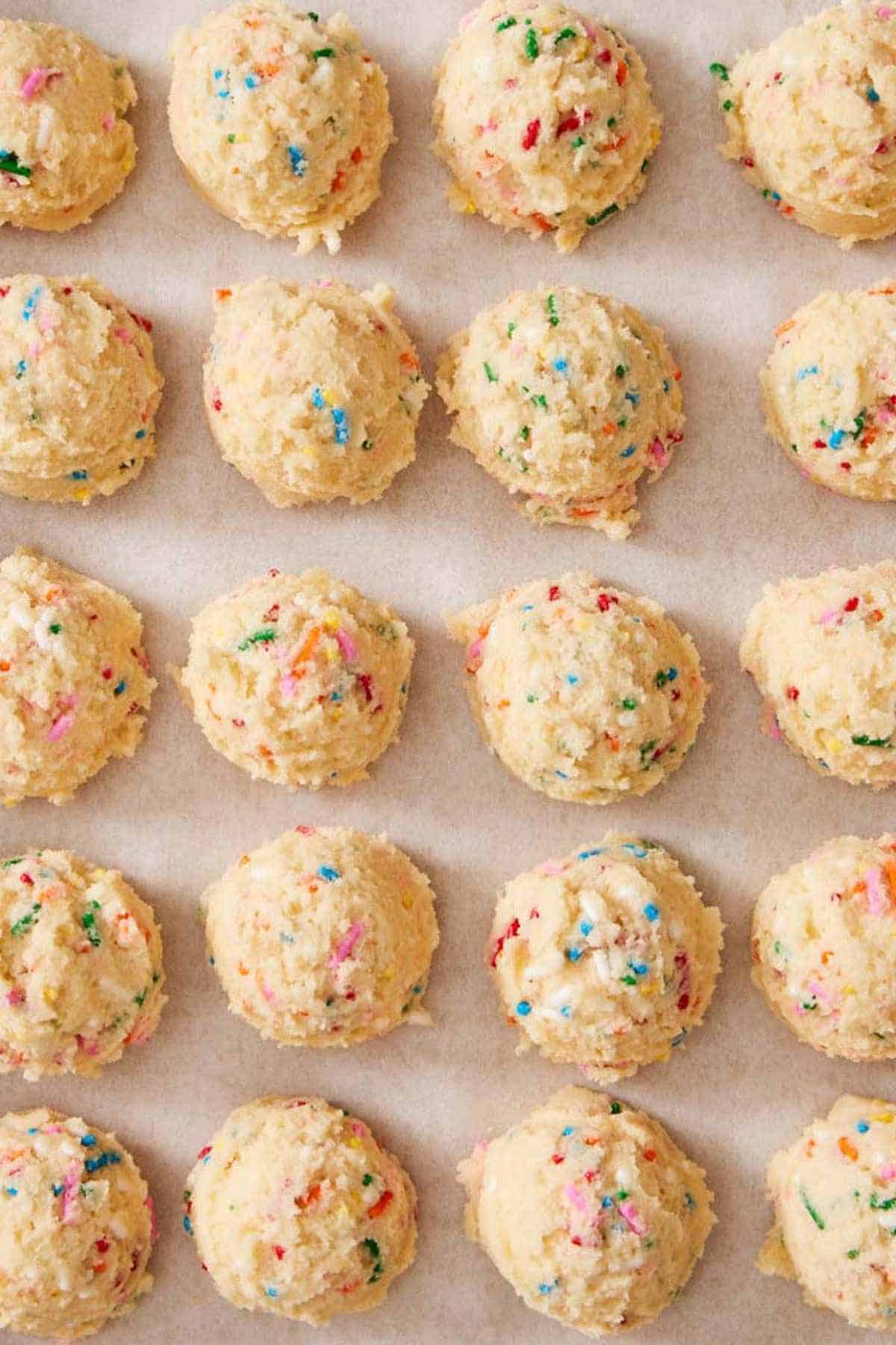 Overhead shot of scoops of funfetti cookie dough in neat rows.
