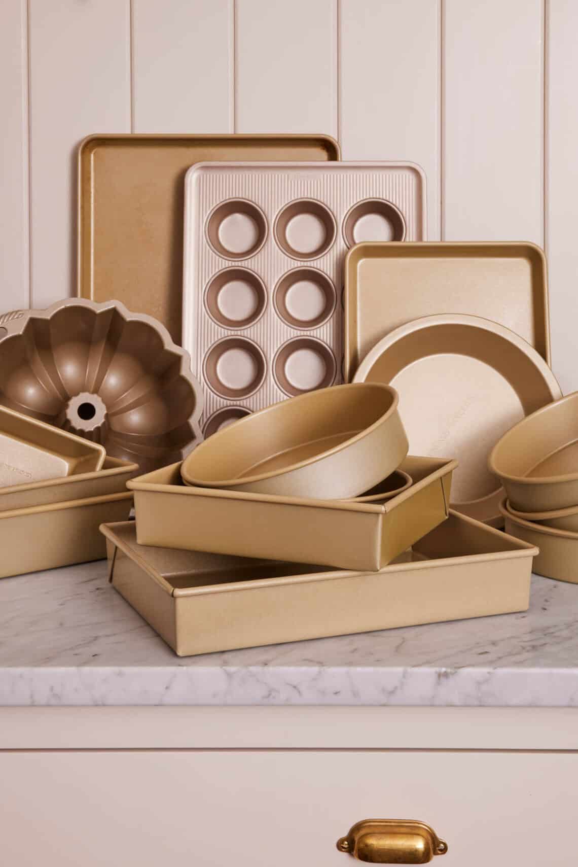 Various baking pans on a marble counter.