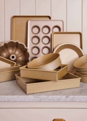 Various baking pans on a marble counter.