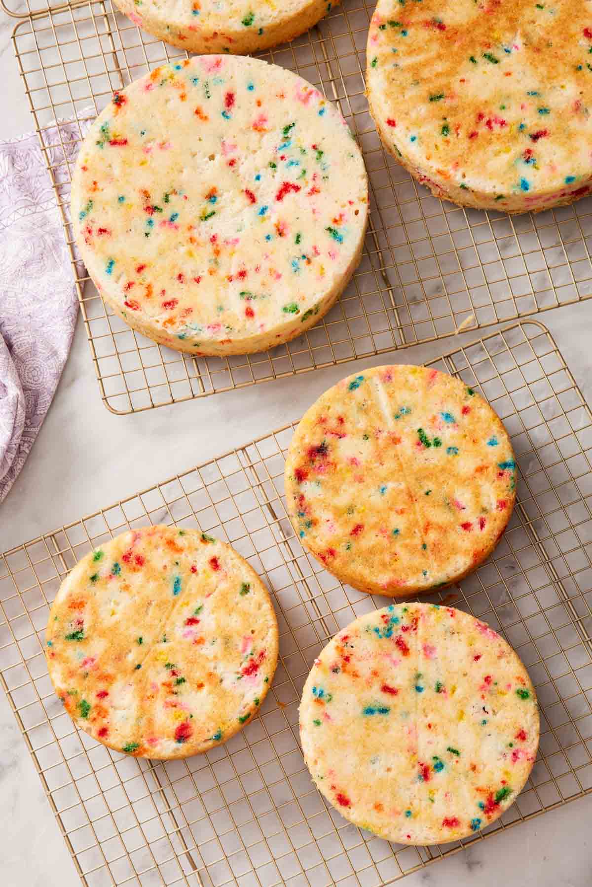 Overhead shot of baked funfetti cake layers of various sizes.
