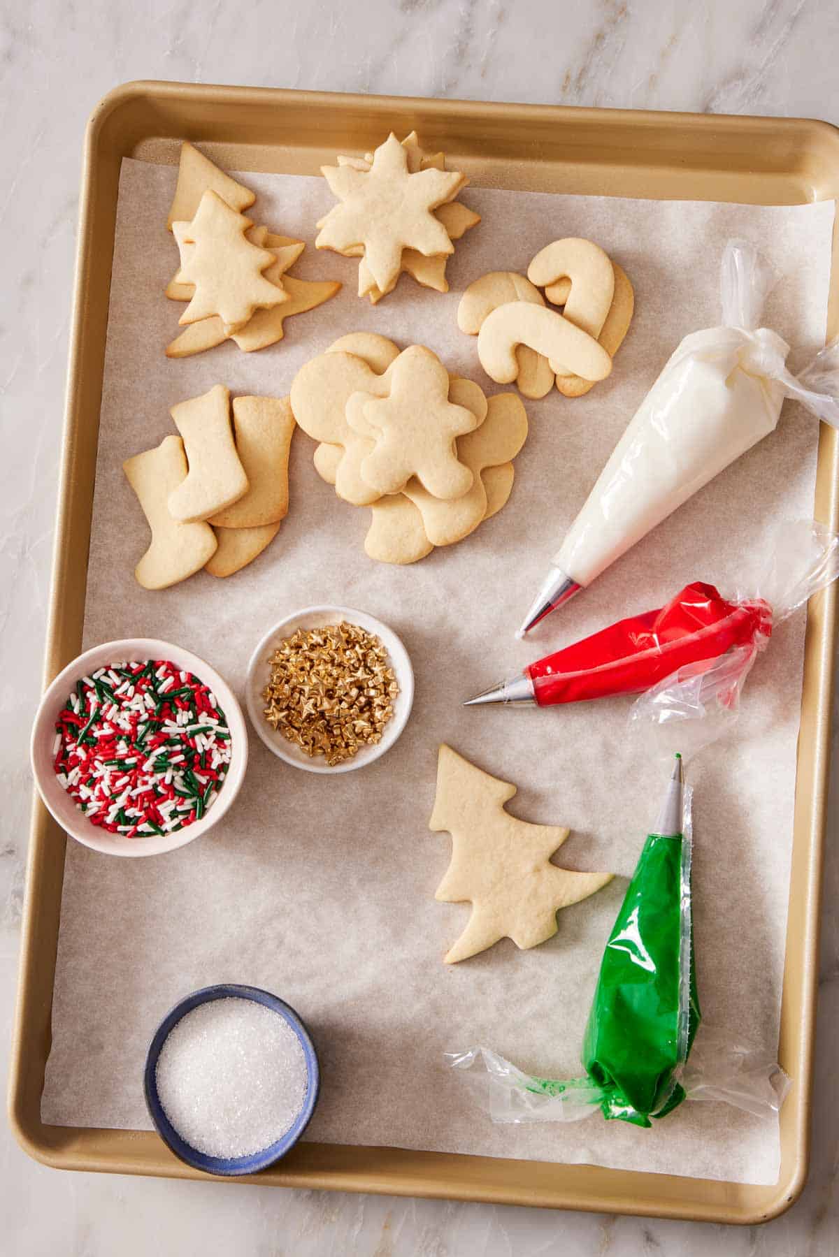 Overhead shot of supplies to host a cookie decorating party.
