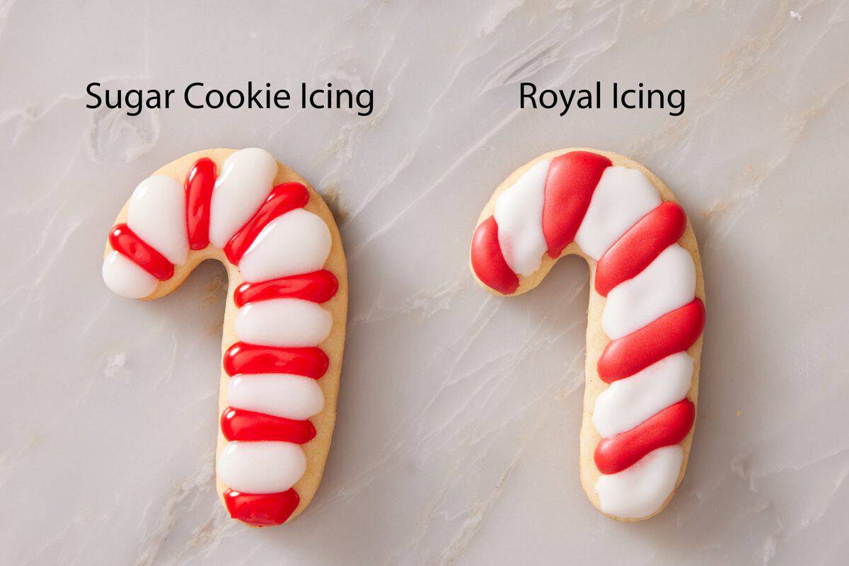 Two candy cane shaped cookies, one iced with sugar cookie icing, the other with royal icing.