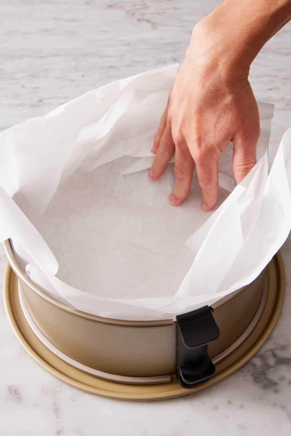 Springform pan fully lined with parchment paper.
