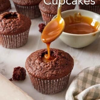 Pinterest graphic showing chocolate cupcake being filled with caramel sauce, and more filled cupcakes in the background.