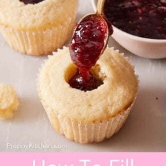 Pinterest graphic showing cupcakes being filled with fruit jam on a marble countertop.
