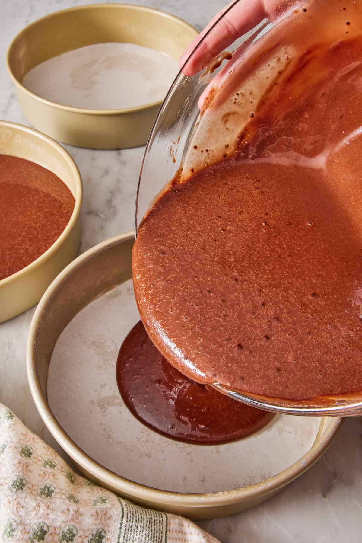 Batter poured into a lined round cake pan.