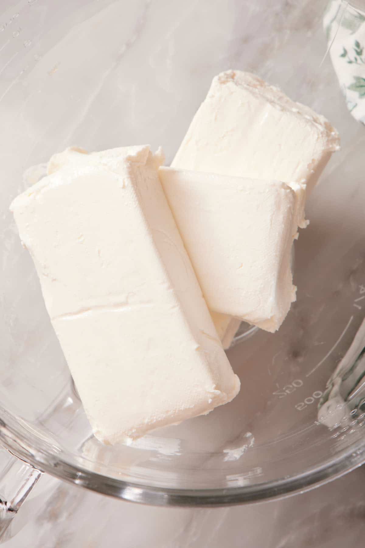 Blocks of cheesecake on a glass bowl.