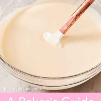 Pinterest graphic showing cheesecake batter in a glass bowl with a spatula.