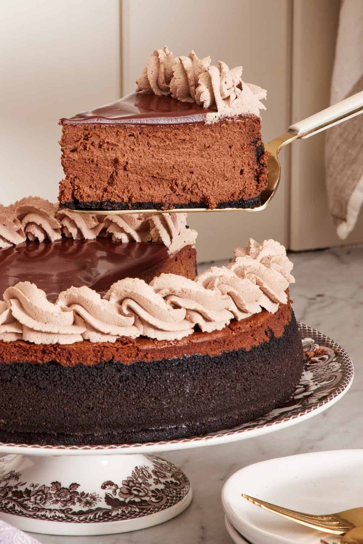 A slice of chocolate cheesecake lifted from the rest of the cheesecake.