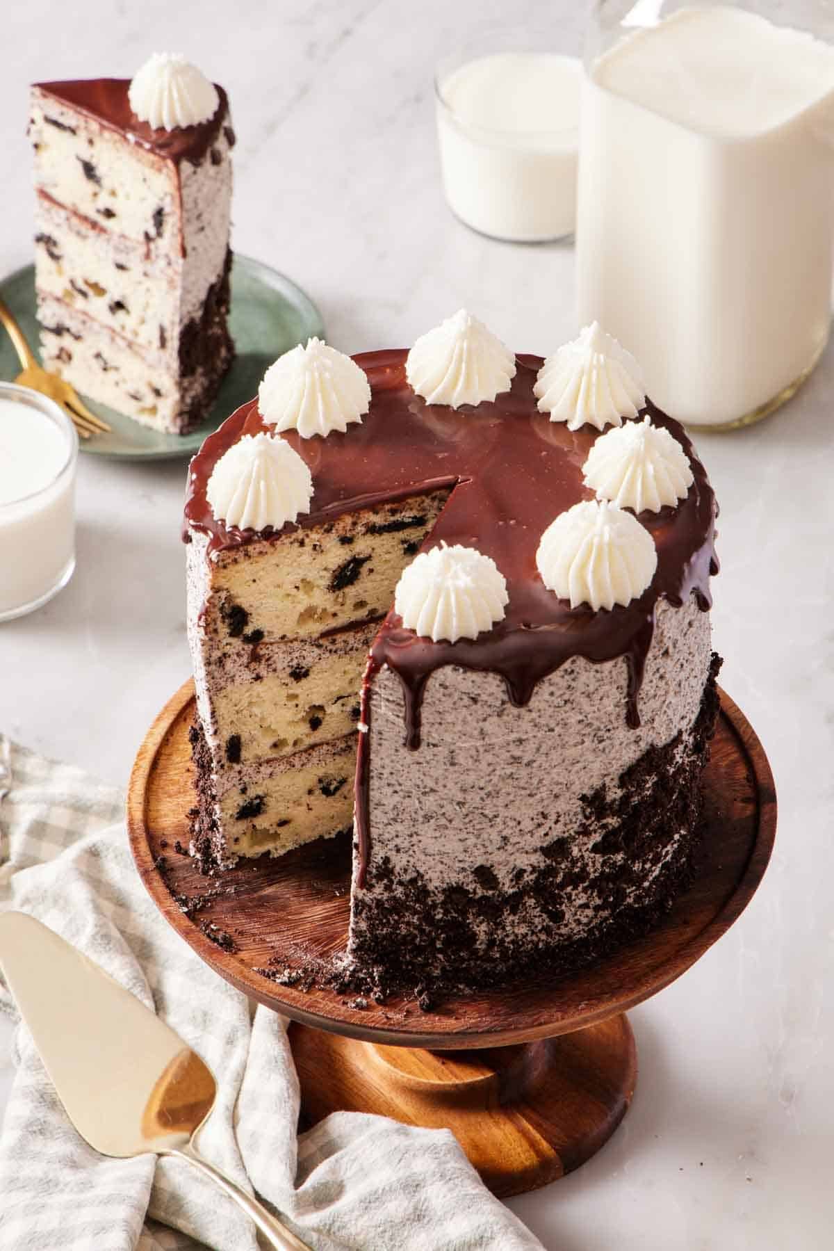 Angled overhead shot of Oreo cake with a slice cut out and on a plate in the background.