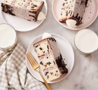 Pinterest graphic showing a overhead shot of three slices of Oreo cake on their side with a few glasses of milk.