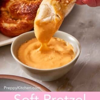 Pinterest graphic showing a piece of soft pretzel recipe dipped into and lifted from a sauce.