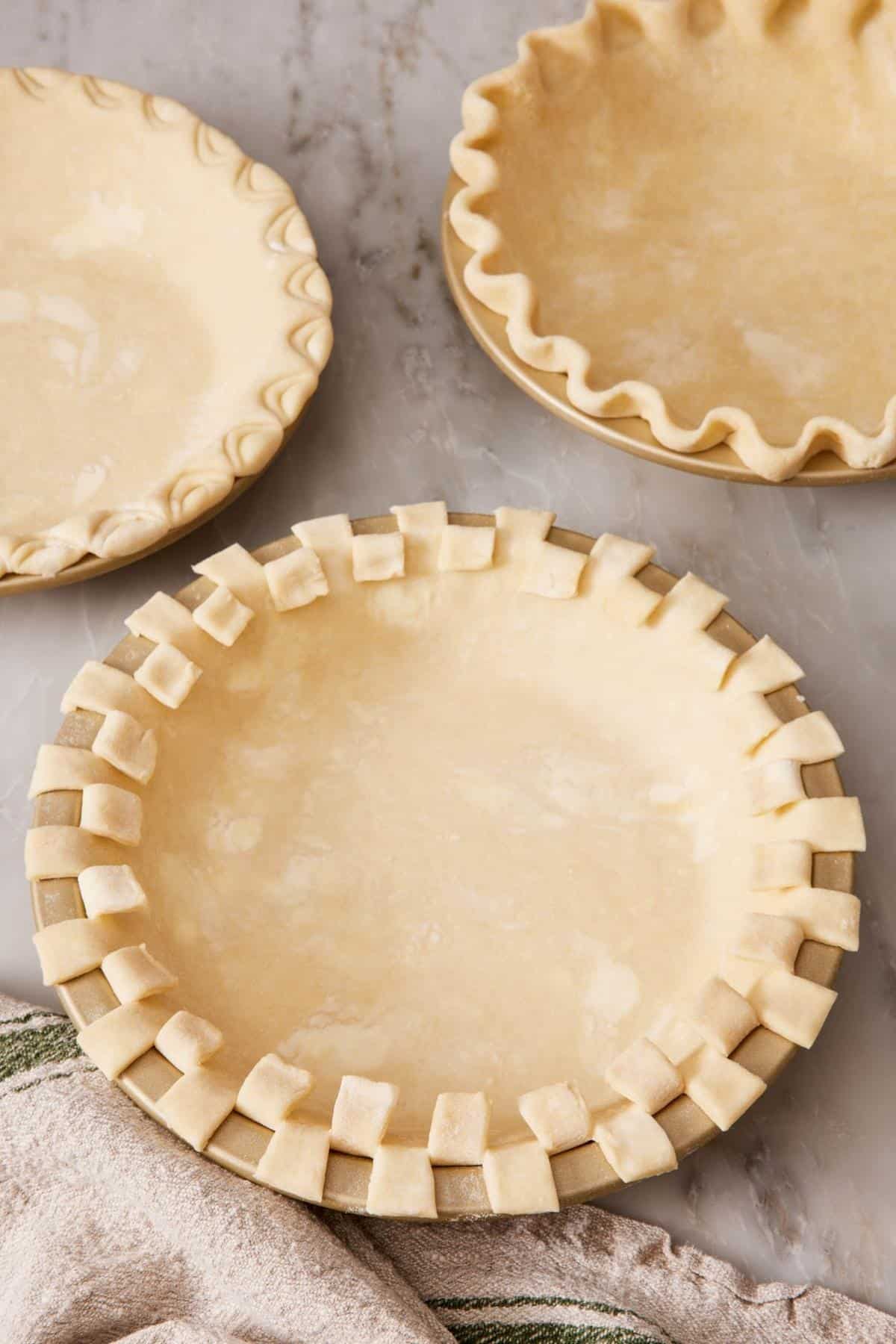 Three pie crust edges decorated in different ways.