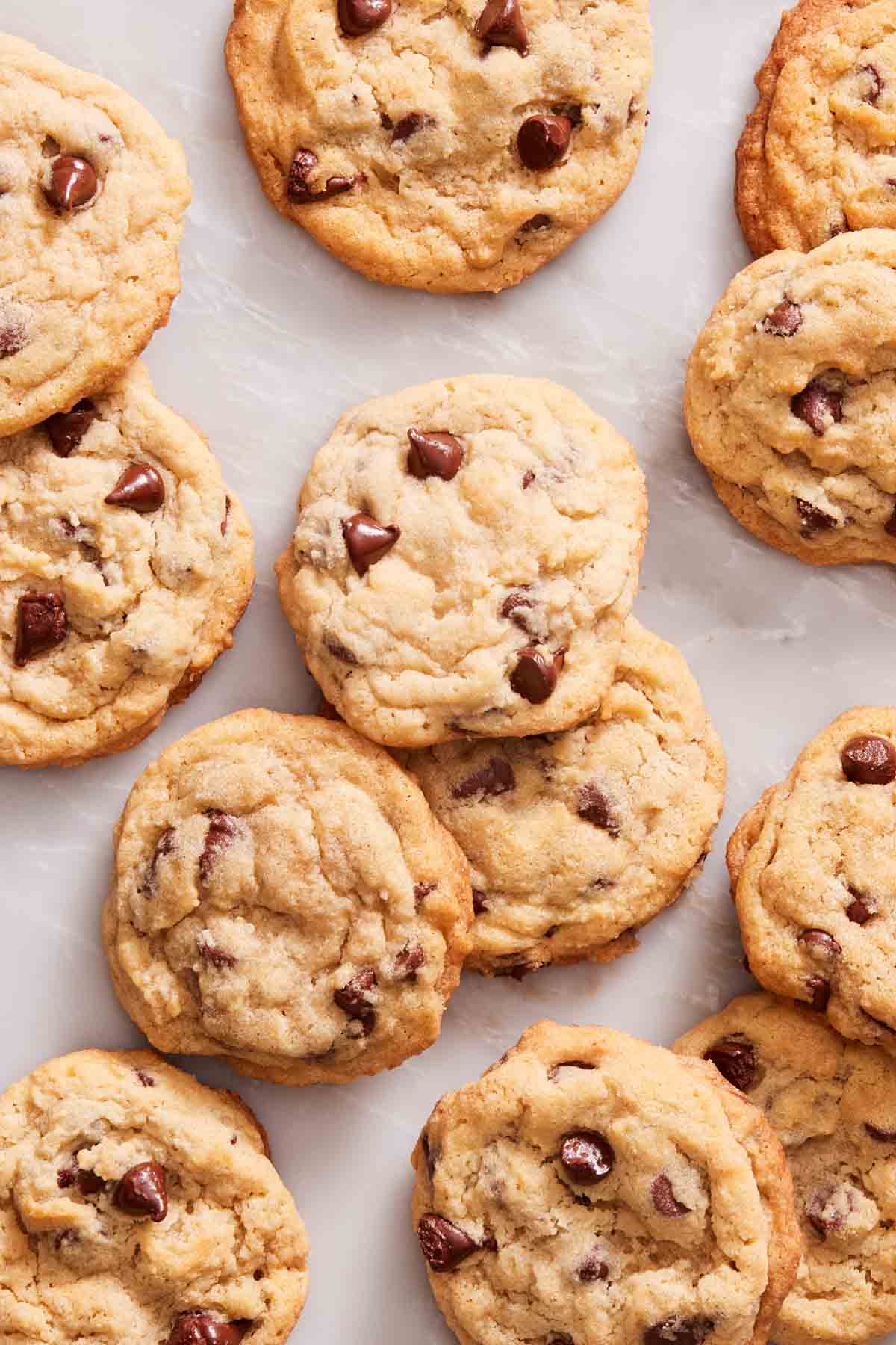 Overhead shot of chocolate chip cookies on a marble countertop.