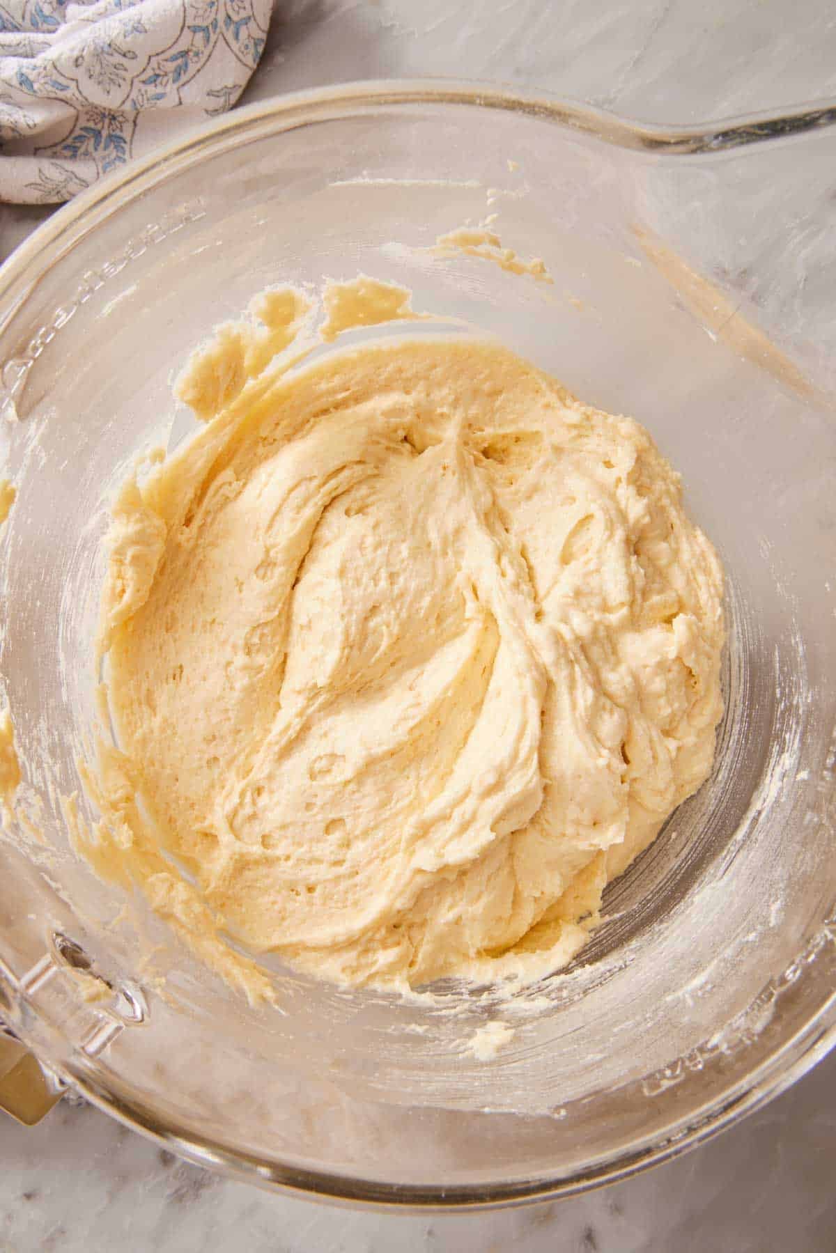 Overhead shot of cake batter in a glass container.