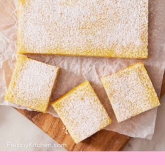 Pinterest graphic showing an overhead shot of a mostly unsliced lemon bar slab, with just a few pieces cut out.