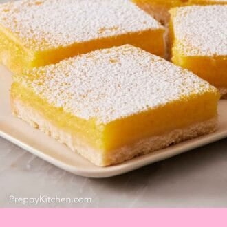 Pinterest graphic showing a side-view close-up of lemon bars on a platter.