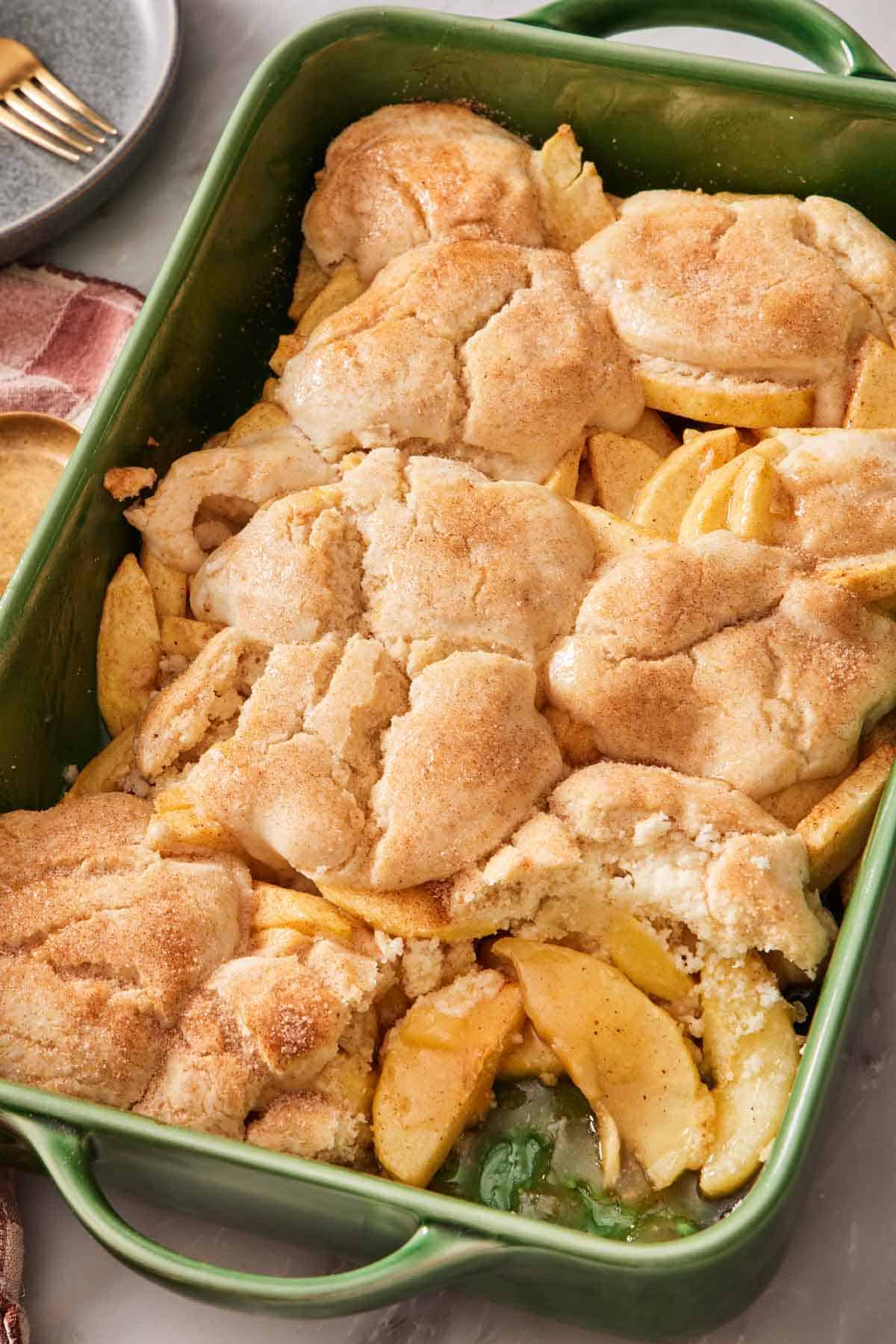 Gluten-free apple cobbler in a green baking dish.