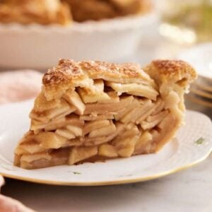 Close-up of a slice of apple pie on a small plate.