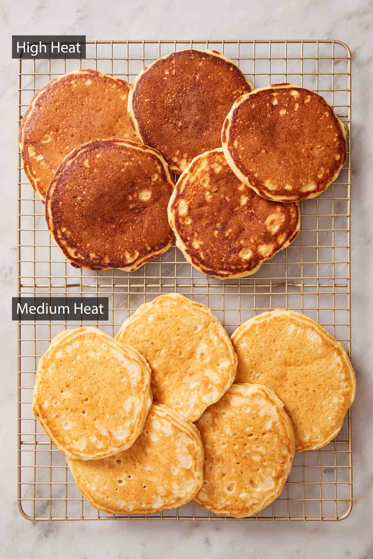 Overhead shot of two piles of pancakes: One cooked over high heat, the other over medium heat.