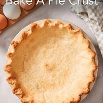 Pinterest graphic showing an overhead shot of a blind-baked crust in a pie dish with eggs off to the side.