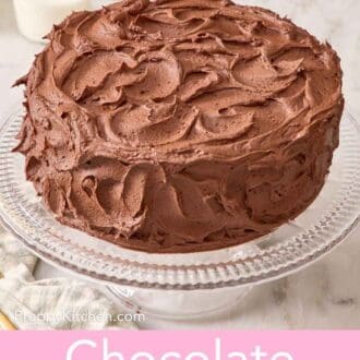 Pinterest graphic showing an entire homemade chocolate cake on a glass cake stand.