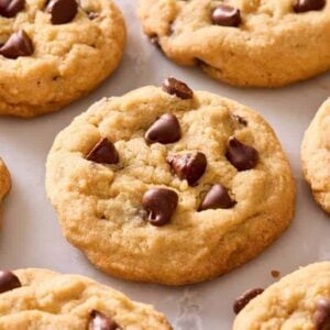Close-up of chocolate chip cookies on a marble countertop.