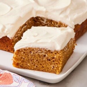 A slice of pumpkin cake slightly pulled away from the rest of the cake.