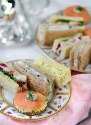 A photo showing English tea sandwiches arranged on a painted porcelain plate